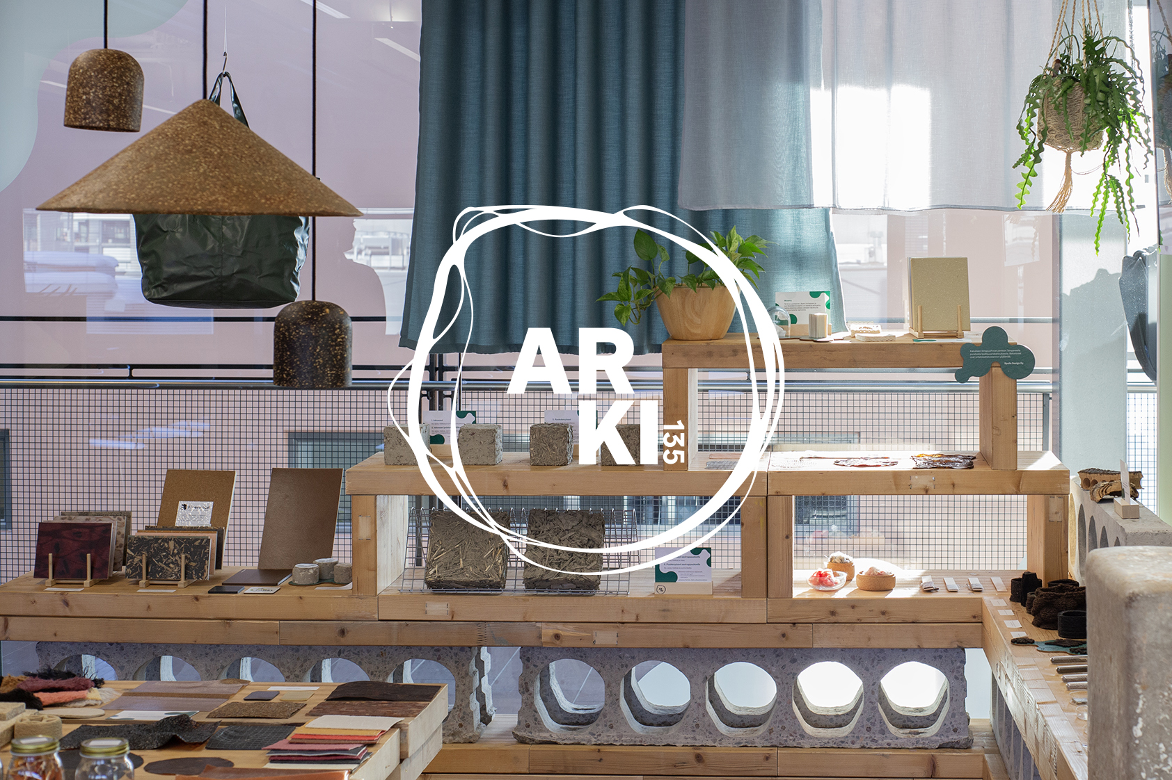 View of the showroom, natural materials on display. ARKI 135 logo in the middle.